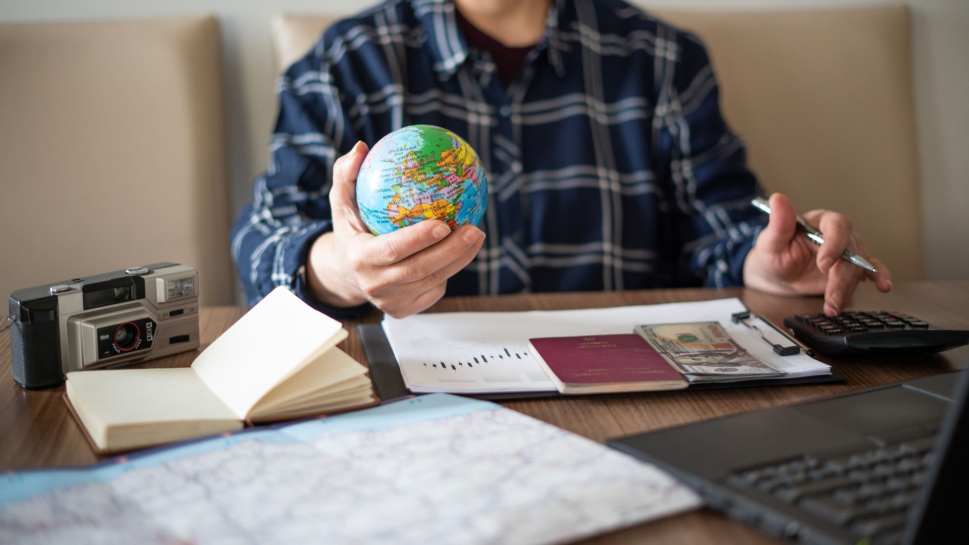 Close-up Woman planning vacation with world map